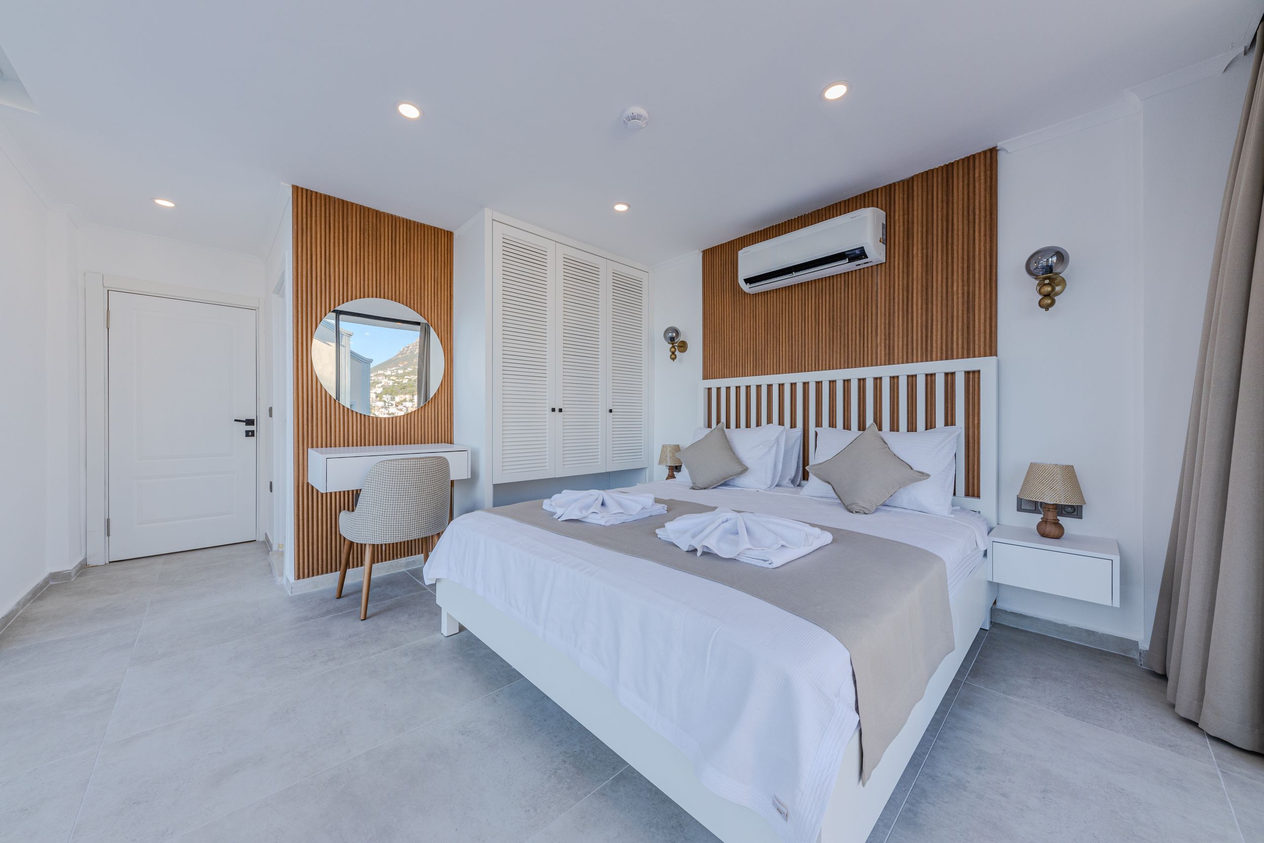 Spacious and airy modern bedroom featuring a double bed and stylish furnishings.